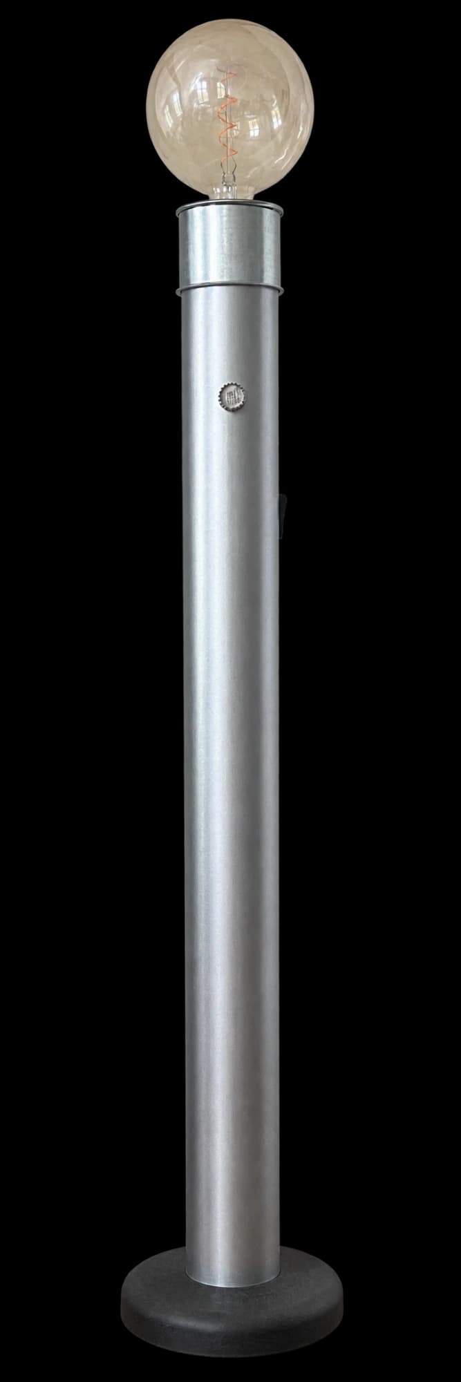 A tall floor lamp: a galvanized steel tube on a round black base, topped with a large globe bulb