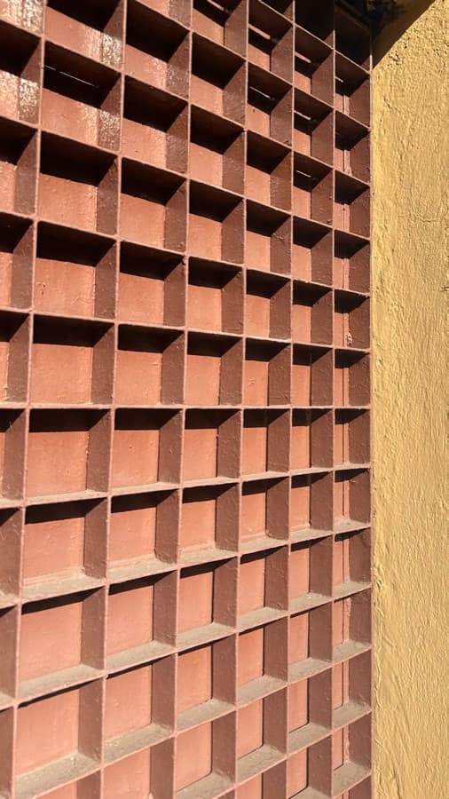 A wall of terracotta grid cubbies