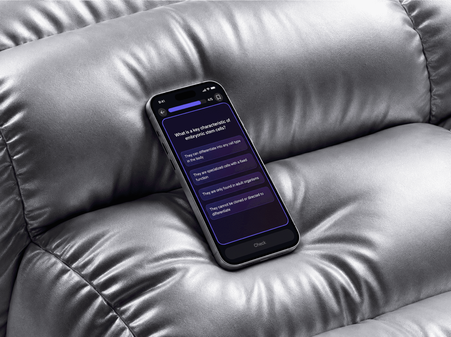 Knowunity quiz screen on a phone resting on a silver padded surface